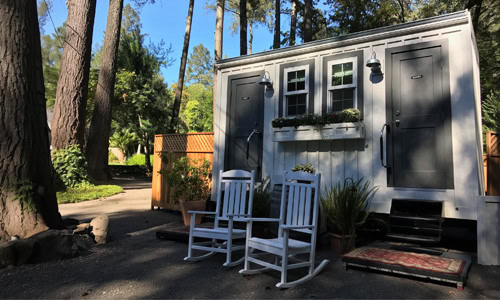 Compact luxury restroom trailer with floral window boxes