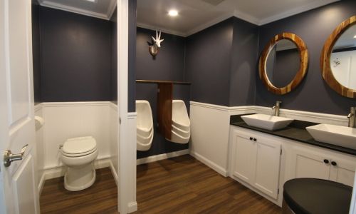 Men's restroom with urinals and dual sinks